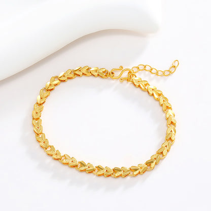 Pulsera de aleación chapada en oro con forma de corazón con flores hechas a mano