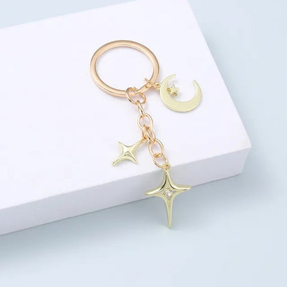 Llave de aleación con forma de estrella y luna de moda creativa